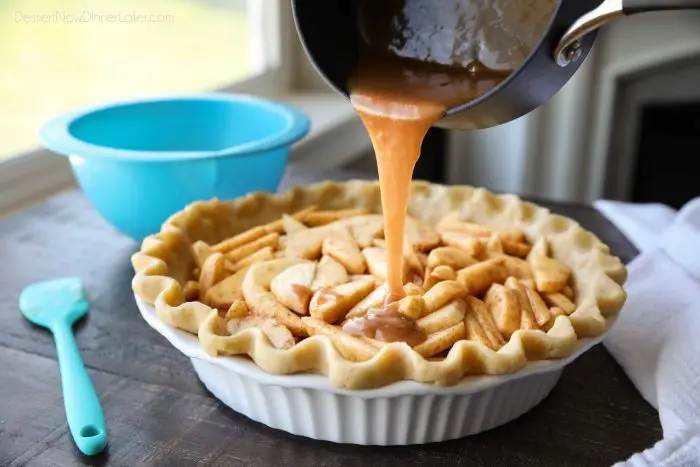 A cinnamon-sugar glaze is poured over fresh apples in a pastry crust.