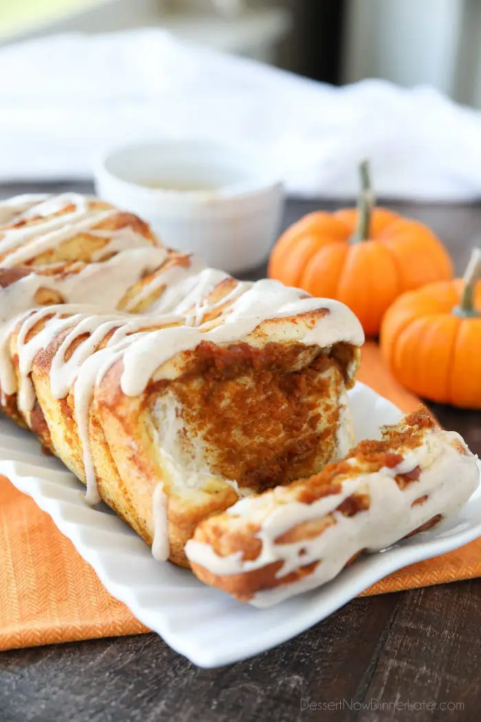 Pumpkin Pull Apart Bread with layers of pumpkin, spices, and real store-bought yeast dough, topped with a cream cheese glaze.