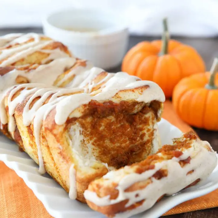 Pumpkin Pull Apart Bread with layers of pumpkin, spices, and real store-bought yeast dough, topped with a cream cheese glaze.