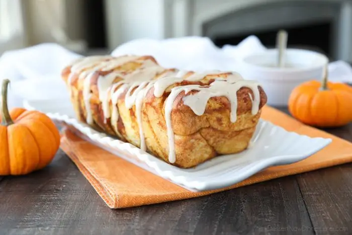 Pumpkin Pull Apart Bread is as delicious as sweet rolls, but super easy to make with layers of pumpkin, spices, and real store-bought yeast dough, not biscuits. Top it with a cream cheese glaze for a delicious seasonal breakfast or dessert.