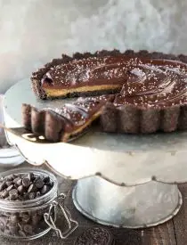 This easy Chocolate Caramel Tart has an Oreo cookie crust, soft caramel filling, and creamy chocolate ganache topped with flaky kosher salt. It's a rich and satisfying chocolate dessert that looks fancy, but is easy to make.