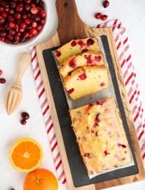 Cranberry Orange Bread is a wonderful treat for the holidays, with a sweet orange glaze on top and pops of tart cranberries throughout. Great for Christmas breakfast or a neighbor gift.