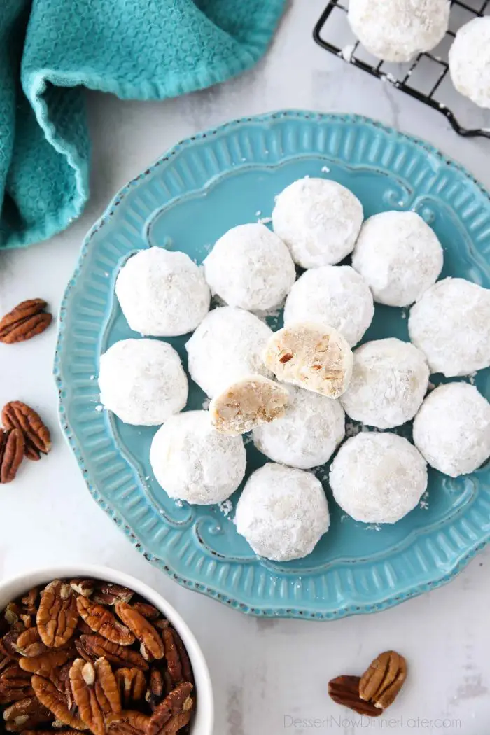 Snowball Cookies are round buttery shortbread cookies with chunks of pecans all rolled in powdered sugar. They melt in your mouth and are a delicious Christmas cookie.