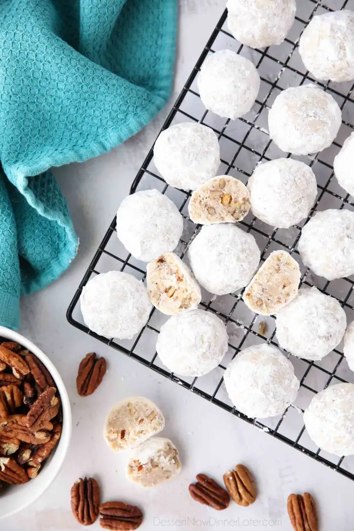 Snowball Cookies are round buttery shortbread cookies with chunks of pecans all rolled in powdered sugar. They melt in your mouth and are a delicious Christmas cookie.