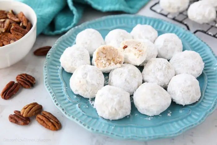 Snowball Cookies are round buttery shortbread cookies with chunks of pecans all rolled in powdered sugar. Other names for these cookies include Italian Wedding Cookies, Russian Tea Cakes, Mexican Wedding Cookies, or Southern Pecan Butterball Cookies.
