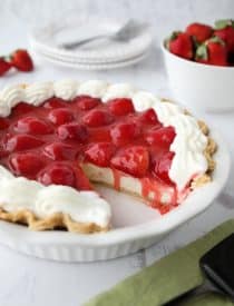 Strawberry Cream Pie is light, fruity, and delicious. With layers of pie crust, no-bake cheesecake, and slices of fresh strawberries smothered in a sweet glaze.