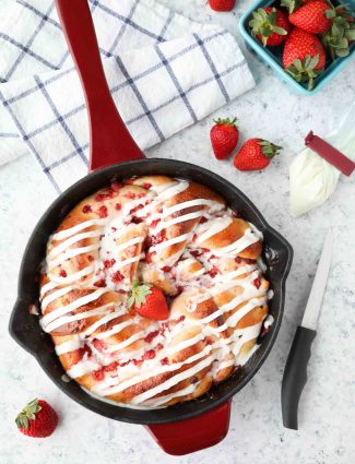 Strawberry Swirl Bread is a twist on classic sweet rolls. Sweet strawberry preserves and chunks of fresh strawberries are twisted inside of soft yeast bread, then baked until golden. Top it with a creamy icing and this easy sweet bread is perfect for breakfast or dessert.