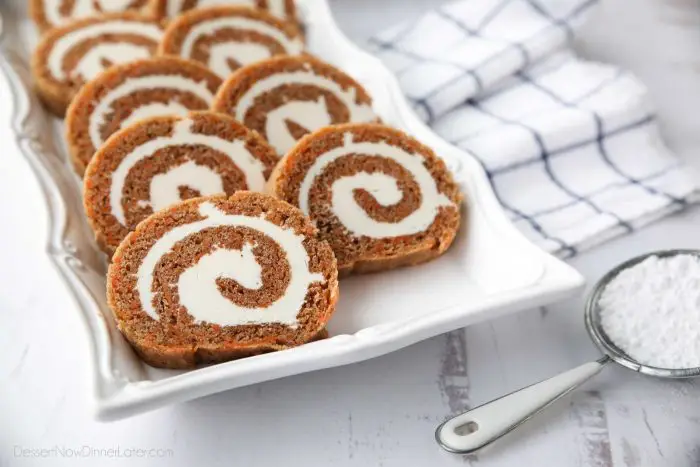 This Carrot Cake Roll is a classic Easter dessert with a twist. Spiced carrot cake is rolled up with the best cream cheese frosting inside. It's beautiful, delicious, and easy to make.