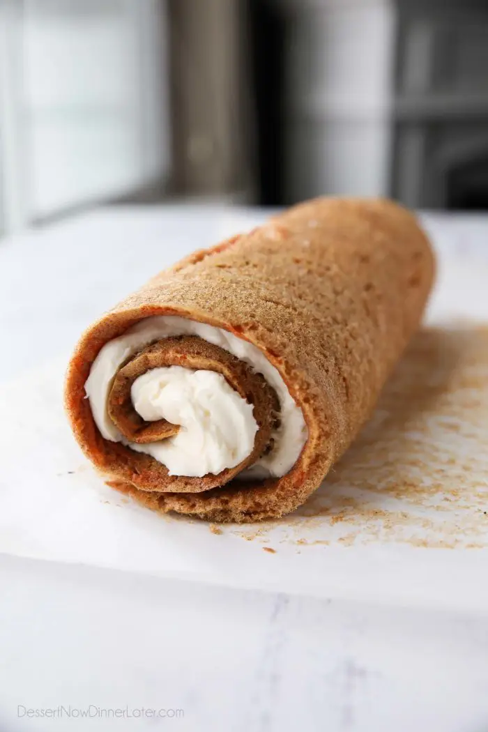 Cream cheese frosting rolled up inside of carrot cake.