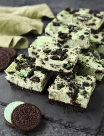 Mint Oreo Cheesecake Bars - a dessert for the mint chocolate lovers. With a mint Oreo crust, and a cool and creamy mint cheesecake loaded with extra chunks of mint Oreos throughout.