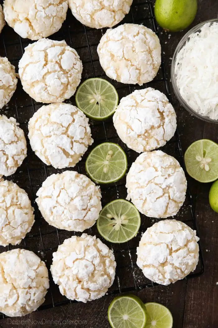 Powdered sugar coated crinkle cookies with key lime juice and zest and sweetened coconut flakes.