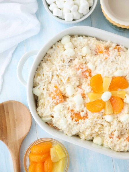 Frog Eye Salad is a creamy, fruity, dessert pasta salad that feeds a crowd. Made easy with vanilla pudding (no eggs), whipped topping, acini di pepe pasta, pineapple, mandarin oranges, coconut, and marshmallows. Perfect for any family reunion, bbq, party, or potluck.