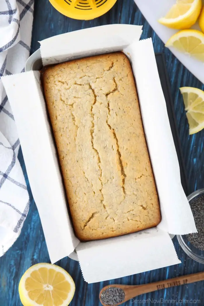 Loaf of Lemon Poppy Seed Bread in a pan with parchment paper for easy removal and even baking.