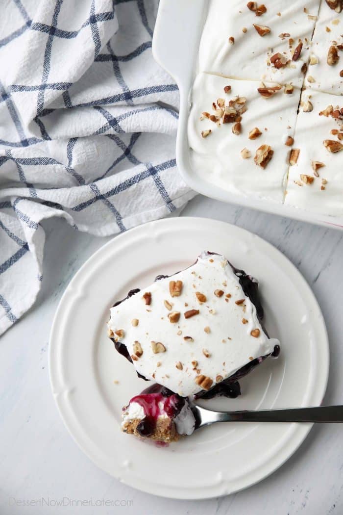 Blueberry Delight is a (nearly) no bake dessert with a graham cracker crust, topped with a cream cheese layer, blueberry pie filling, and cool whip.