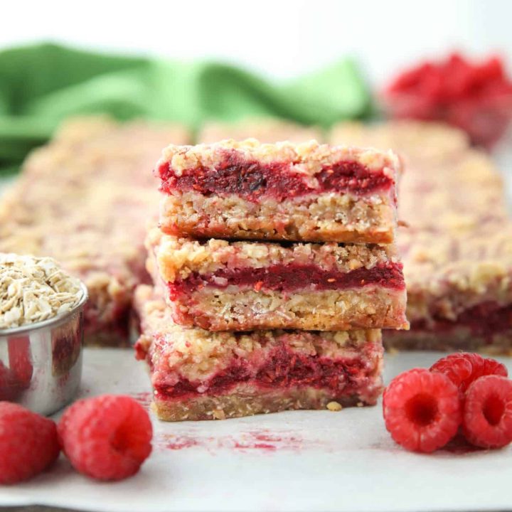 Three Raspberry Crumble Bars stacked on top of each other.