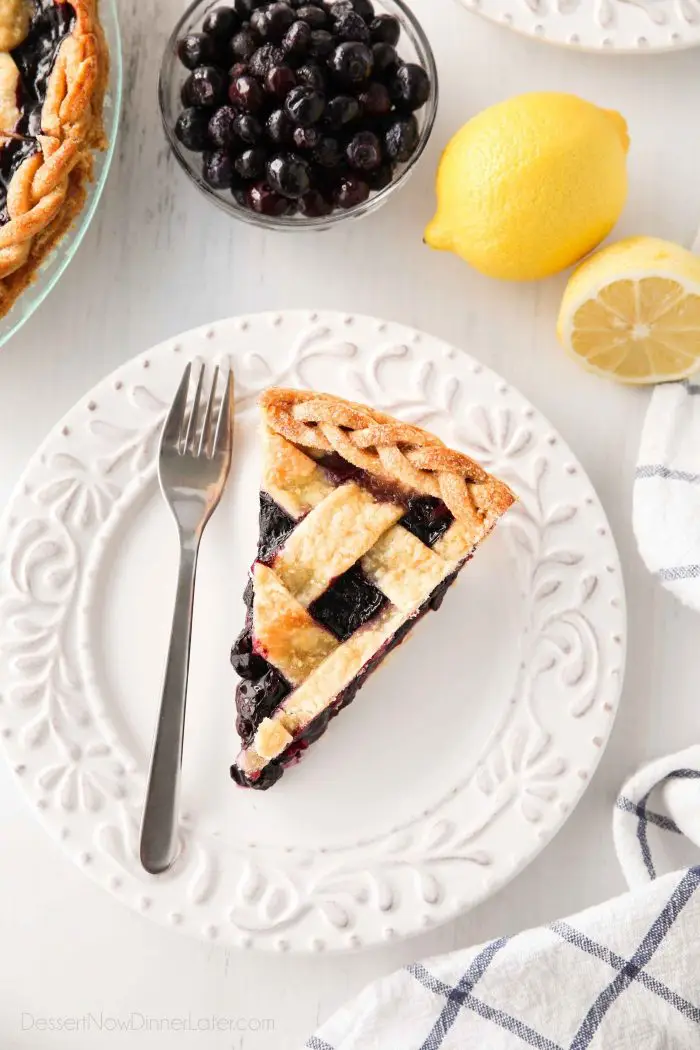 Slice of homemade blueberry pie made with frozen blueberries and a hint of lemon.