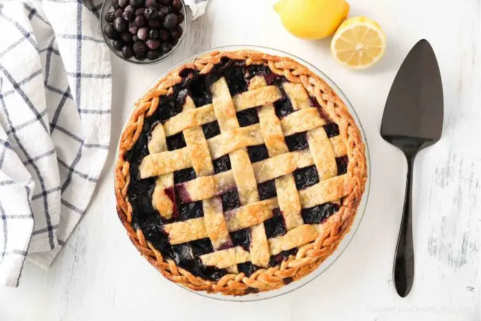 Whole blueberry pie with lattice crust and braided edges.