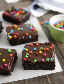 These homemade cosmic brownies are even better than store-bought! Rich, fudgy brownies are topped with a creamy chocolate ganache and candy coated chocolate chips. They're easy to make from scratch and not just for lunchbox treats!