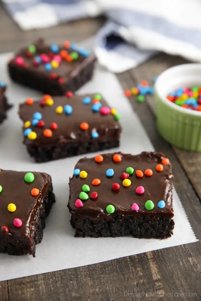 These homemade cosmic brownies are even better than store-bought! Rich, fudgy brownies are topped with a creamy chocolate ganache and candy coated chocolate chips. They're easy to make from scratch and not just for lunchbox treats!