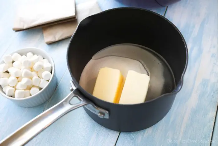 Marshmallow Popcorn starts by melting butter, sugar, and corn syrup together.