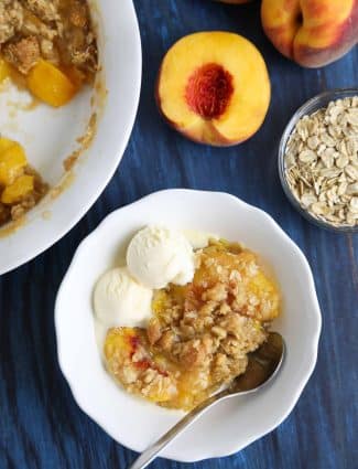 This easy peach crisp recipe (aka peach crumble) is loaded with fresh, juicy peaches topped with a generous helping of buttery brown sugar and oat streusel. Enjoy it with warm with a scoop of vanilla ice cream.