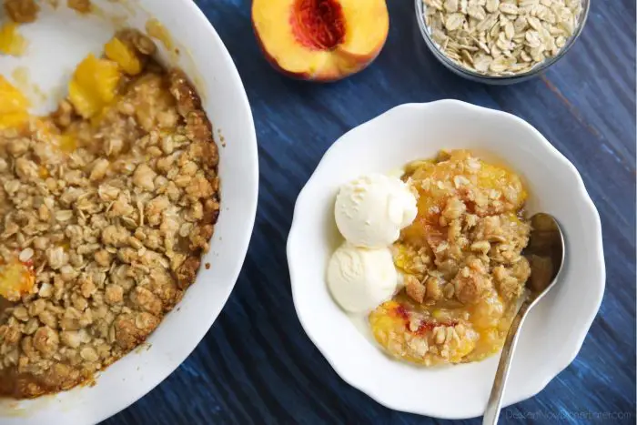 Peach Crisp - Fresh peaches simply sweetened, topped with a crunchy oat topping, and served warm with vanilla ice cream.