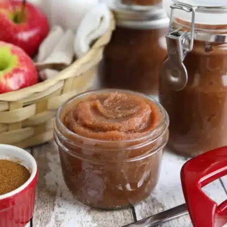 Apple butter is thicker than applesauce with a rich caramelized flavor and warm fragrant spices. It's used as a spread, topping, or snack. This homemade apple butter recipe is easy to make from scratch on the stovetop in as little as two hours.