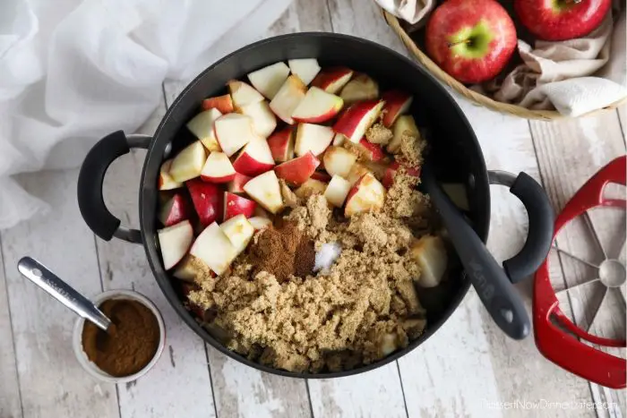 How to make apple butter: Place diced apples, brown sugar, cinnamon, cloves, salt, lemon and apple juice in a pot.