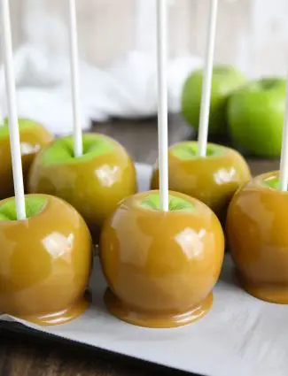 Classic homemade caramel apples are fun to make from scratch. Any leftover caramel can be cooled, cut, and wrapped for treats. Plus tips and tricks to make professional looking caramel apples at home.