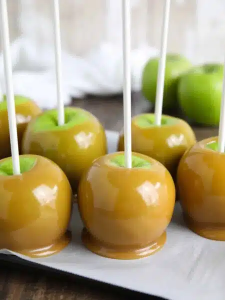 Classic homemade caramel apples are fun to make from scratch. Any leftover caramel can be cooled, cut, and wrapped for treats. Plus tips and tricks to make professional looking caramel apples at home.