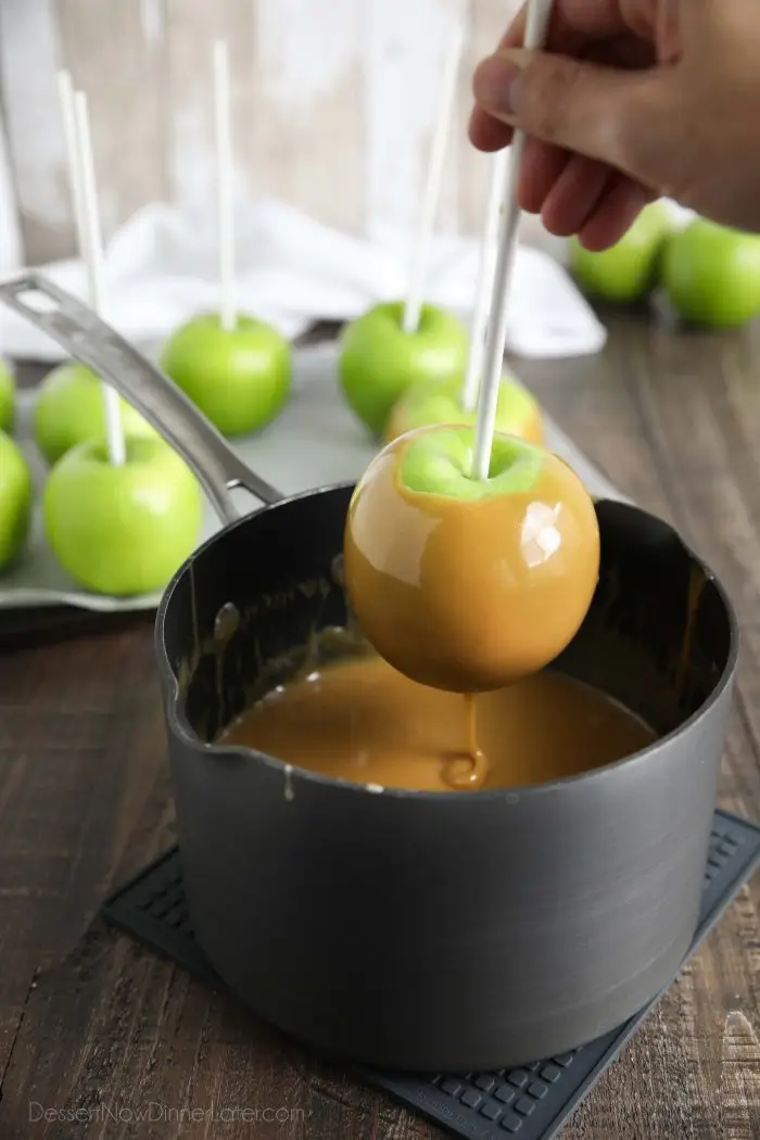 Dipping a Granny Smith apple into easy homemade caramel.