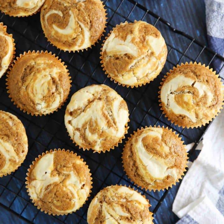 Pumpkin cream cheese muffins are light, fluffy, and moist, full of pumpkin spice flavor, and swirled with creamy cheesecake.