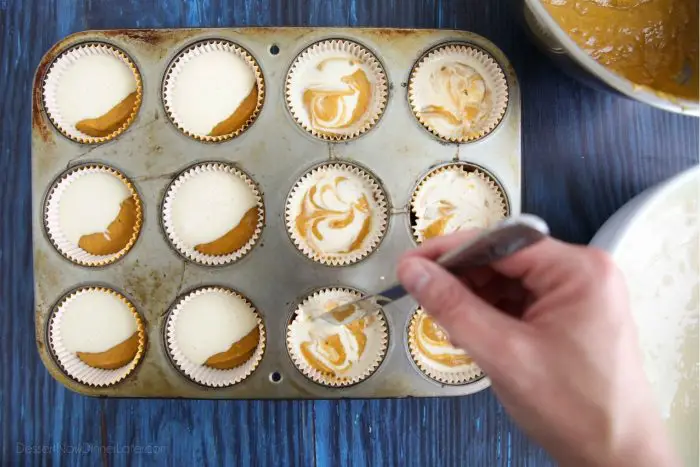 To make Pumpkin Cream Cheese Muffins: Scoop the pumpkin muffin batter on bottom and the cheesecake batter on top. Fold the two batters together with a knife for a swirled look.