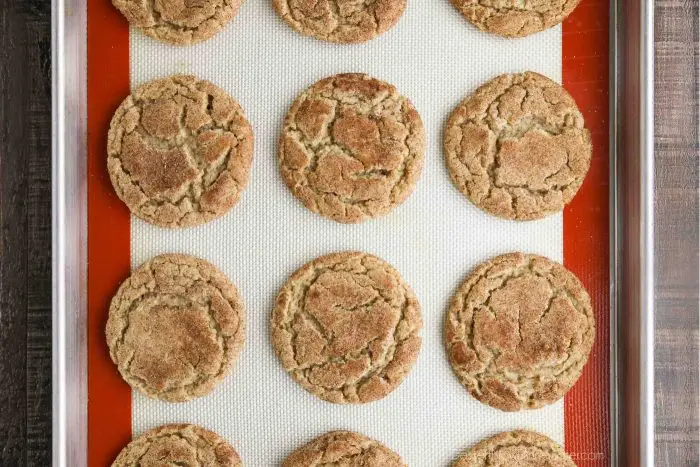 Top view of baked apple butter cookies on a cookie sheet.