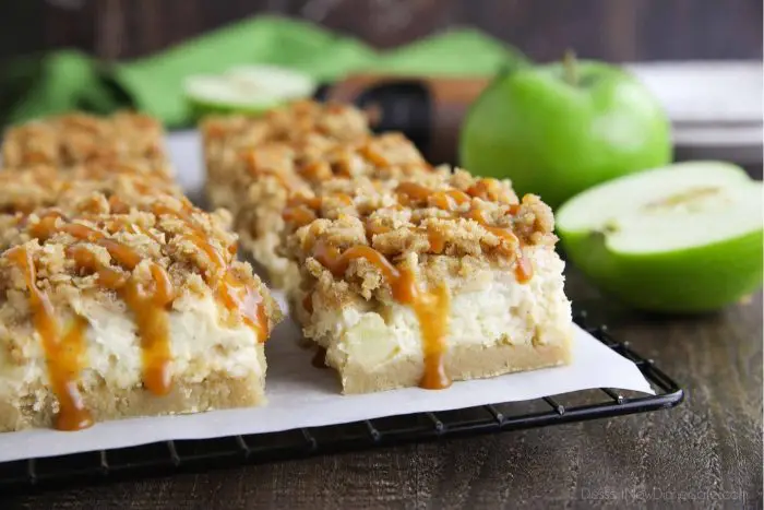 Close up of caramel apple cheesecake bars with caramel dripping down the side.