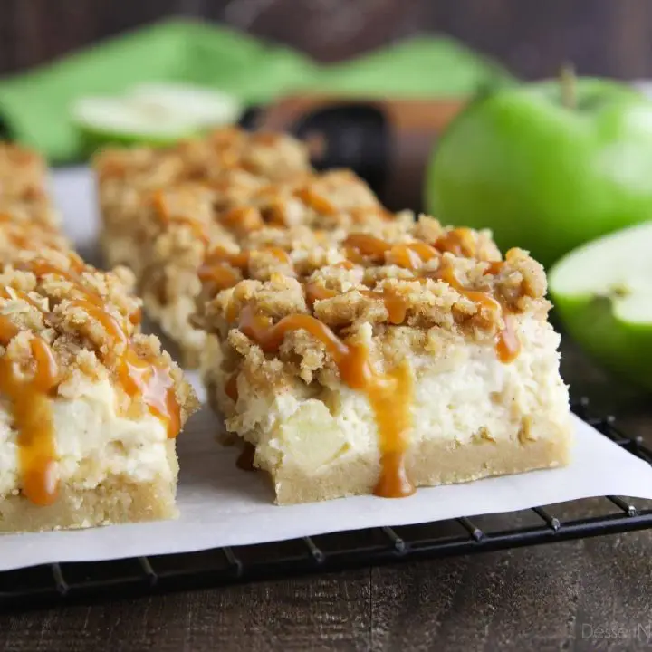 Close up of caramel apple cheesecake bars with caramel dripping down the side.
