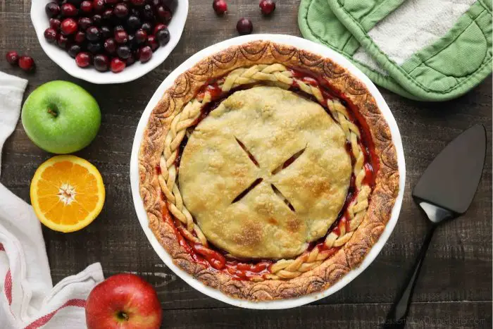 A whole apple cranberry pie with braided crust.