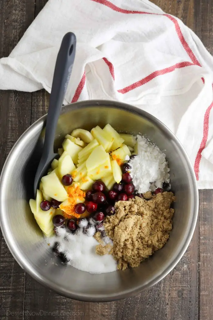 Apple and cranberry pie filling ingredients in a bowl.