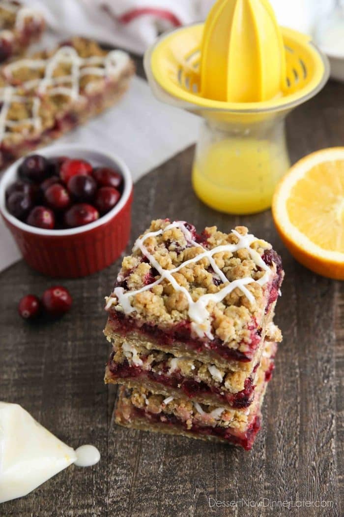 Cranberry Crumble Bars stacked with glaze drizzled on top.