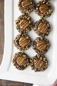 Turtle Thumbprint Cookies on long white rectangle platter.