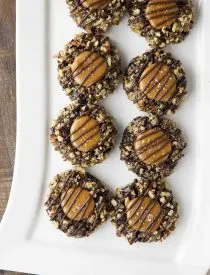 Turtle Thumbprint Cookies on long white rectangle platter.