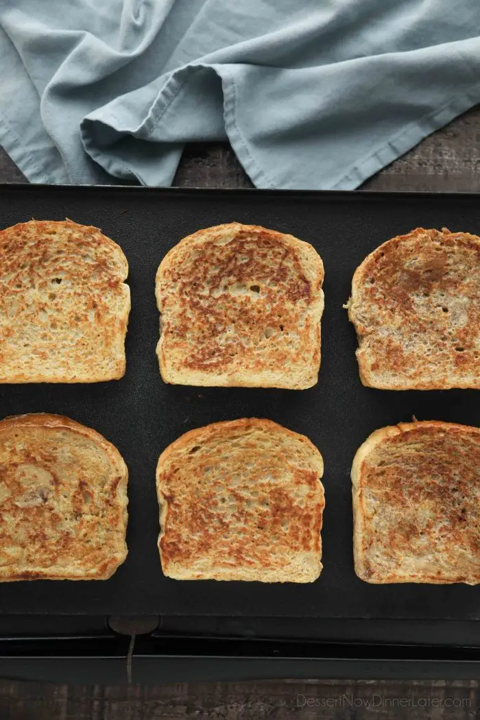 Homemade French toast being cooked on a griddle.