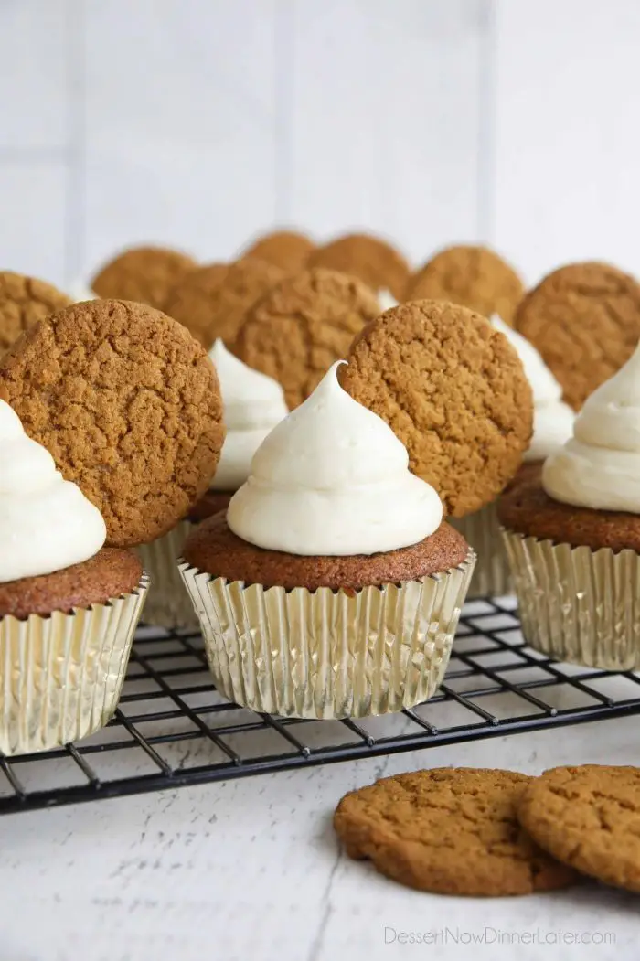 Gingerbread cupcakes with cream cheese frosting and a gingersnap cookies on top.