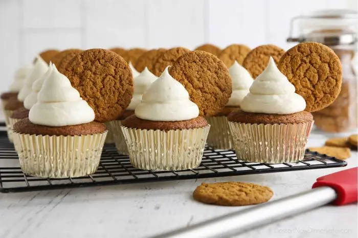 Gingerbread cupcakes with cream cheese frosting and a gingersnap cookies on top.