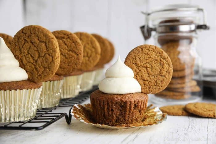 Spiced gingerbread cupcake with cream cheese frosting and a gingersnap cookie on top.
