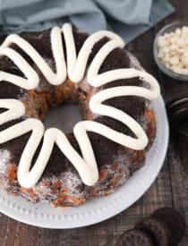 Angled view of Cookies and Cream Monkey Bread on a plate with zig-zagged cream cheese frosting on top.