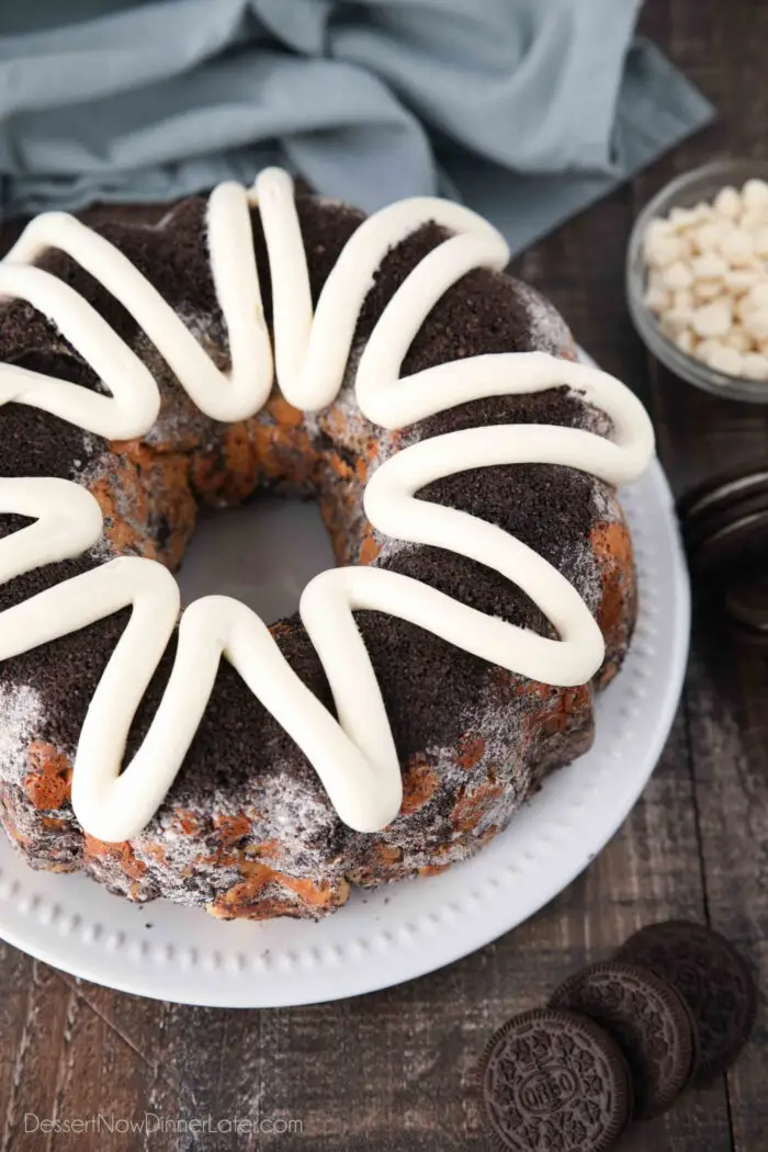 Angled view of Cookies and Cream Monkey Bread on a plate with zig-zagged cream cheese frosting on top.