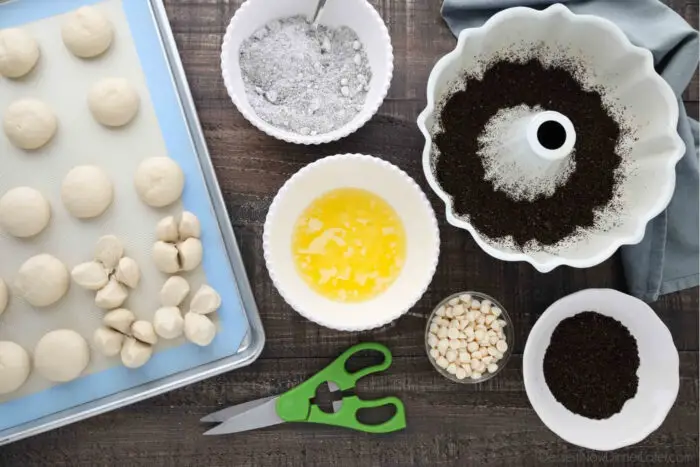 Ingredients for Oreo Monkey Bread: Rhodes rolls, crushed Oreo chocolate sandwich cookies, Oreo pudding mix, melted butter, white chocolate chips.