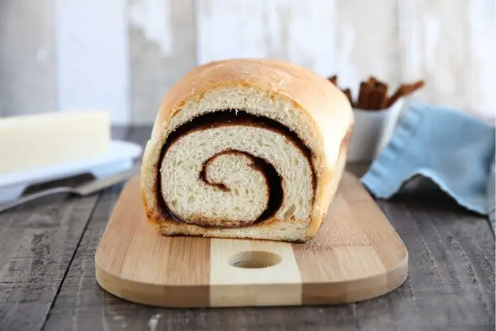 Cinnamon Bread on cutting board with cinnamon swirl showing.