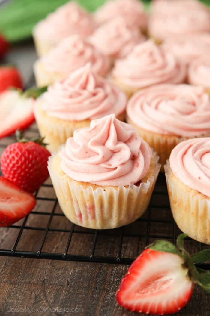 Strawberry cupcakes with strawberry frosting piped on top.